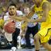 Louisville senior Peyton Siva knocks the ball loose from Michigan sophomore Trey Burke during the second half of the national championship game at the Georgia Dome in Atlanta on Monday, April 8, 2013. Melanie Maxwell I AnnArbor.com
